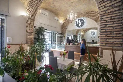 a woman standing in front of a restaurant at Hotel Centro Cavour Roma in Rome