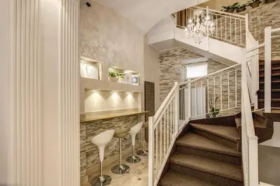 a staircase in a home with stools and a stair case at Hotel Centro Cavour Roma in Rome