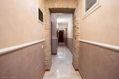 a hallway with a brick wall and a hallway with a hallway at Hotel Centro Cavour Roma in Rome