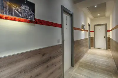 a hallway with wooden flooring and a painting on the wall at Hotel Raganelli in Rome