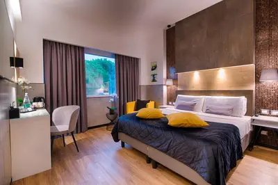 a bedroom with a bed with yellow pillows on it at Hotel Raganelli in Rome