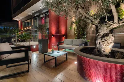 a lobby with a tree and a couch and a table at Hotel Raganelli in Rome