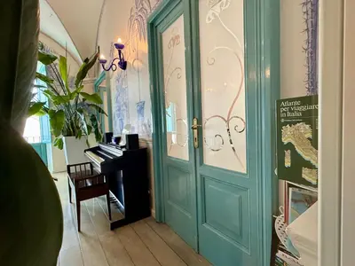 a door leading into a room with a piano at Lilium Boutique Hotel in Rome