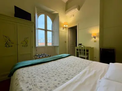 a bedroom with a large bed and a window at Lilium Boutique Hotel in Rome