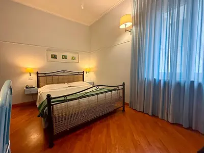 a bedroom with a bed and a large window at Lilium Boutique Hotel in Rome