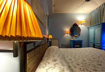 a bedroom with a bed with a yellow head board at Lilium Boutique Hotel in Rome