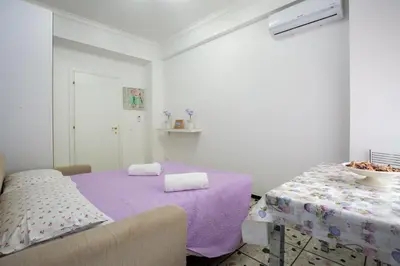 a white room with a bed and a table at Vatican Station in Rome