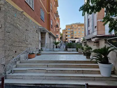 a group of stairs in a city with buildings at Vatican Station in Rome