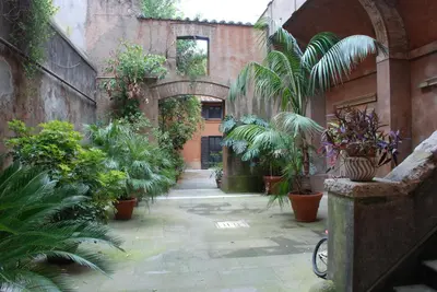 a courtyard with plants in an old building at Palazzo Velli Suites in Rome
