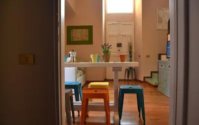 a kitchen with a table and stools in a room at Palazzo Velli Suites in Rome