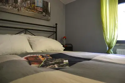 a bedroom with a bed with a book on it at Palazzo Velli Suites in Rome