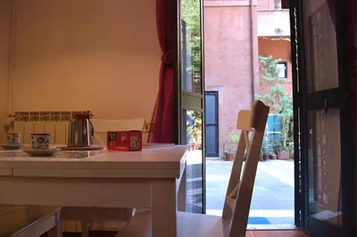 a kitchen with a counter and a table and a window at Palazzo Velli Suites in Rome