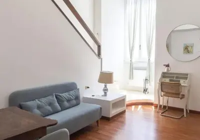 a living room with a couch and a table at Palazzo Velli Suites in Rome