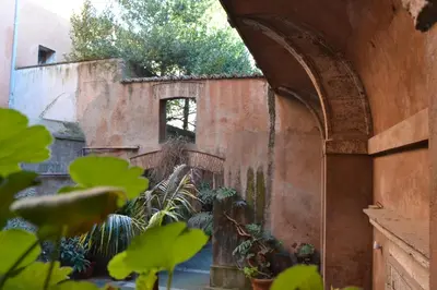 an archway in a building with a bunch of plants at Palazzo Velli Suites in Rome