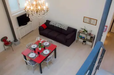 a living room with a table and a couch at Nostromondo Ciancaleoni Palace in Rome