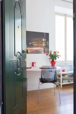 a door with a table and a chair in a room at Nostromondo Ciancaleoni Palace in Rome