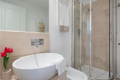 a bathroom with a white tub and a shower at Nostromondo Ciancaleoni Palace in Rome