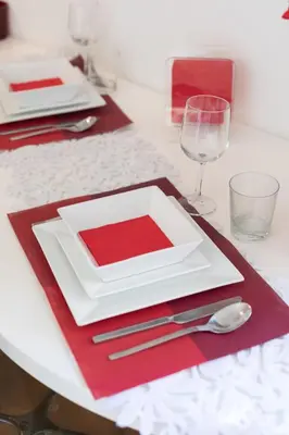 a table with a white plate and a glass of wine at Nostromondo Ciancaleoni Palace in Rome