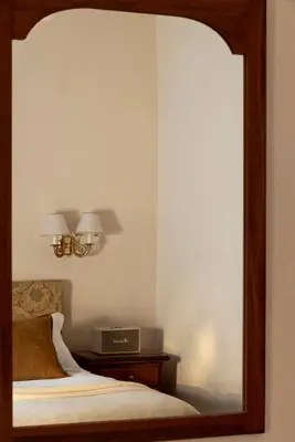 a hotel room with a bed and a chair at Hotel Cortina in Rome