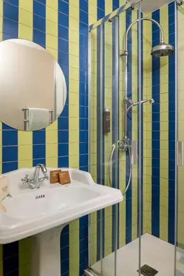 a bedroom with a bed and a mirror and a table at Hotel Cortina in Rome