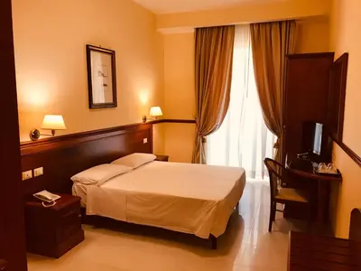 a hotel room with a bed and a window at Hotel Virgilio in Rome