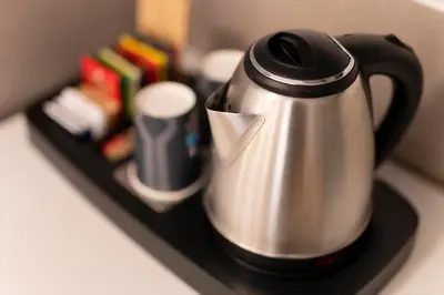 a tea kettle is sitting on a black tray at Hotel Virgilio in Rome