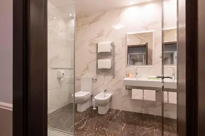 a bathroom with a toilet and a sink and a shower at Hotel Virgilio in Rome