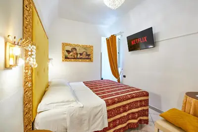a bedroom with a bed and a mirror at Hotel Virginia in Rome
