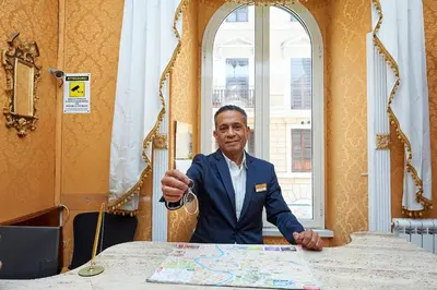 a man in a suit sitting at a table at Hotel Virginia in Rome