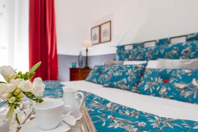 a hotel room with a bed and a tray with coffee cups at All'Orologio in Rome