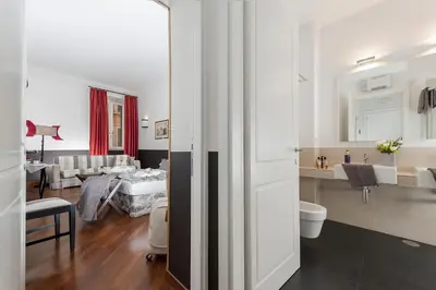 a living room with a bed and a bathroom at All'Orologio in Rome