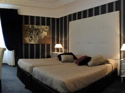 a bedroom with a bed with two pillows on it at Atlante Star Hotel in Rome