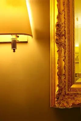a lamp next to a mirror and a lamp shade at Hotel Teti in Rome