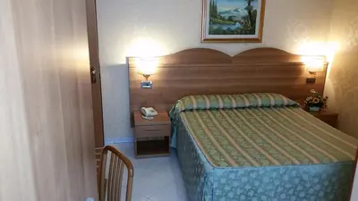a hotel room with a bed and a telephone at Hotel Teti in Rome