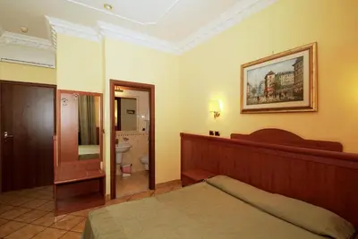a hotel room with a bed and a bathroom at Hotel Meridiana in Rome