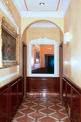 a hallway with a large mirror in a building at Hotel Meridiana in Rome