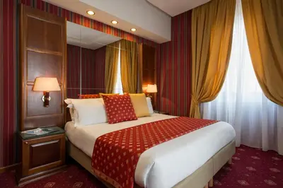a hotel room with a large bed and a window at Atlante Garden Hotel in Rome