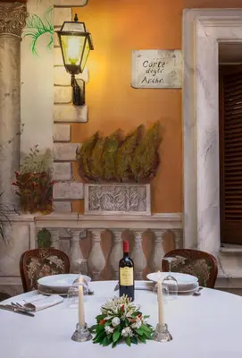 a table with a bottle of wine on it at Grand Hotel Gianicolo in Rome