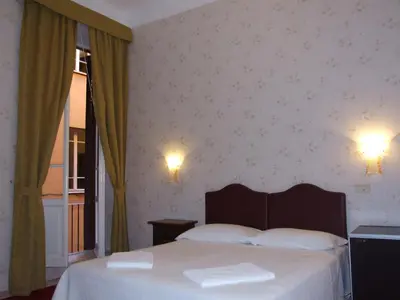 a bedroom with a bed with two towels on it at Hotel Texas in Rome