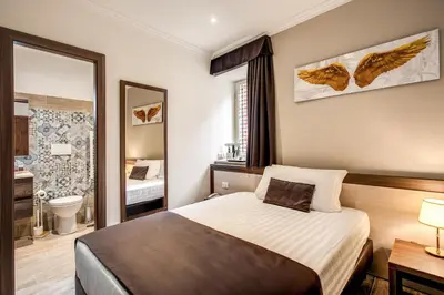 a hotel room with a bed and a mirror at Rome Garden Hotel in Rome
