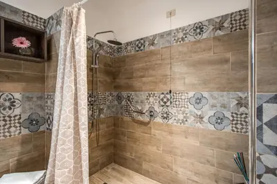a bathroom with a shower with a shower curtain at Rome Garden Hotel in Rome