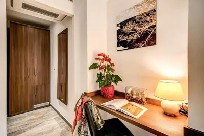 a room with a desk with a lamp and a book at Rome Garden Hotel in Rome