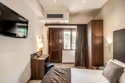 a hotel room with a bed and a television at Rome Garden Hotel in Rome