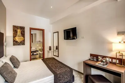 a hotel room with a bed and a television at Rome Garden Hotel in Rome
