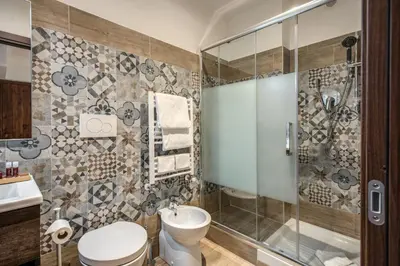 a bathroom with a toilet and a shower at Rome Garden Hotel in Rome