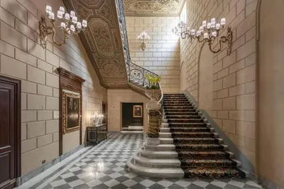 a hallway with a staircase in a building at The St. Regis Rome in Rome