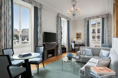 a living room with a couch and a tv at The St. Regis Rome in Rome