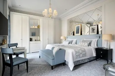 a bedroom with a bed and a chair and a desk at The St. Regis Rome in Rome