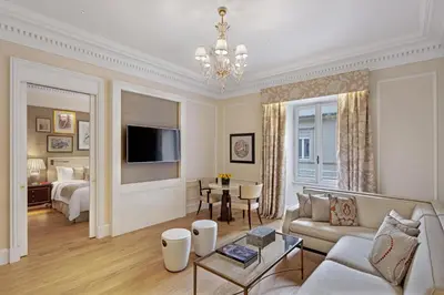 a living room with a couch and a bed at The St. Regis Rome in Rome