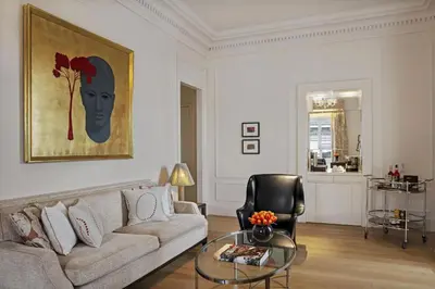 a living room with a couch and a glass table at The St. Regis Rome in Rome